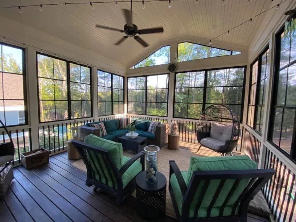 Cozy screened-in porch with modern seating, natural light, and stylish decor.